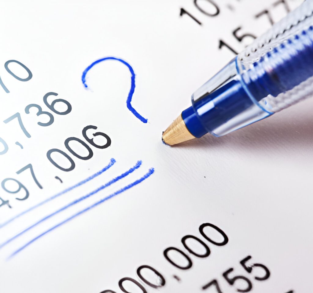 Close-up of a blue pen pointing at a list of numbers on paper, with a blue question mark drawn beside one figure, highlighting uncertainty and potential bookkeeping mistakes small business owners might face.